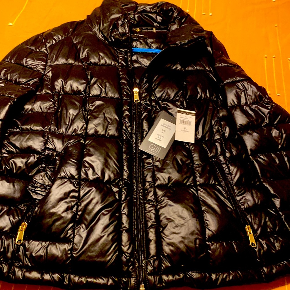 Black puffy jacket with tags
